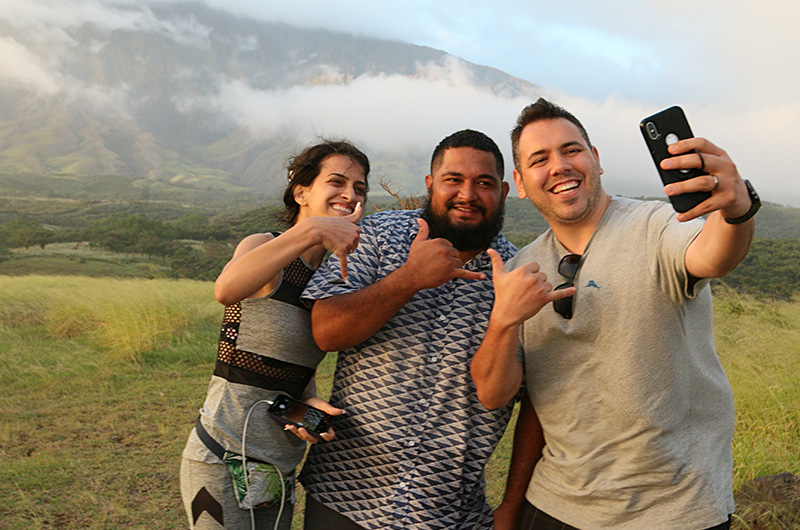 A Road to Hana guide taking a selfie with tour guests.